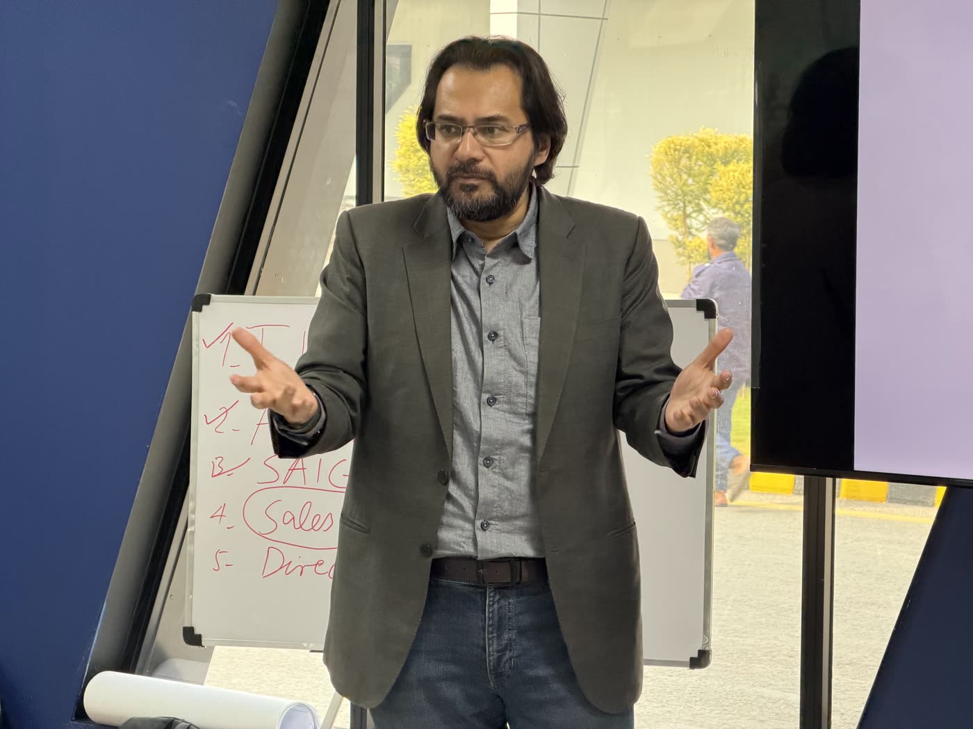 Prof. Dr. Abdul Baseer Qazi working through the parenting framework at a whiteboard